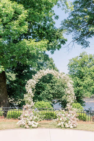 Wedding Arch full of spring pastel flowers overlooking the catawba river. Melissa Mayrie Photography