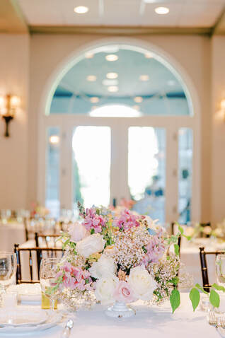 floral centerpiece on decorated table with white linens. Melissa Mayrie Photography